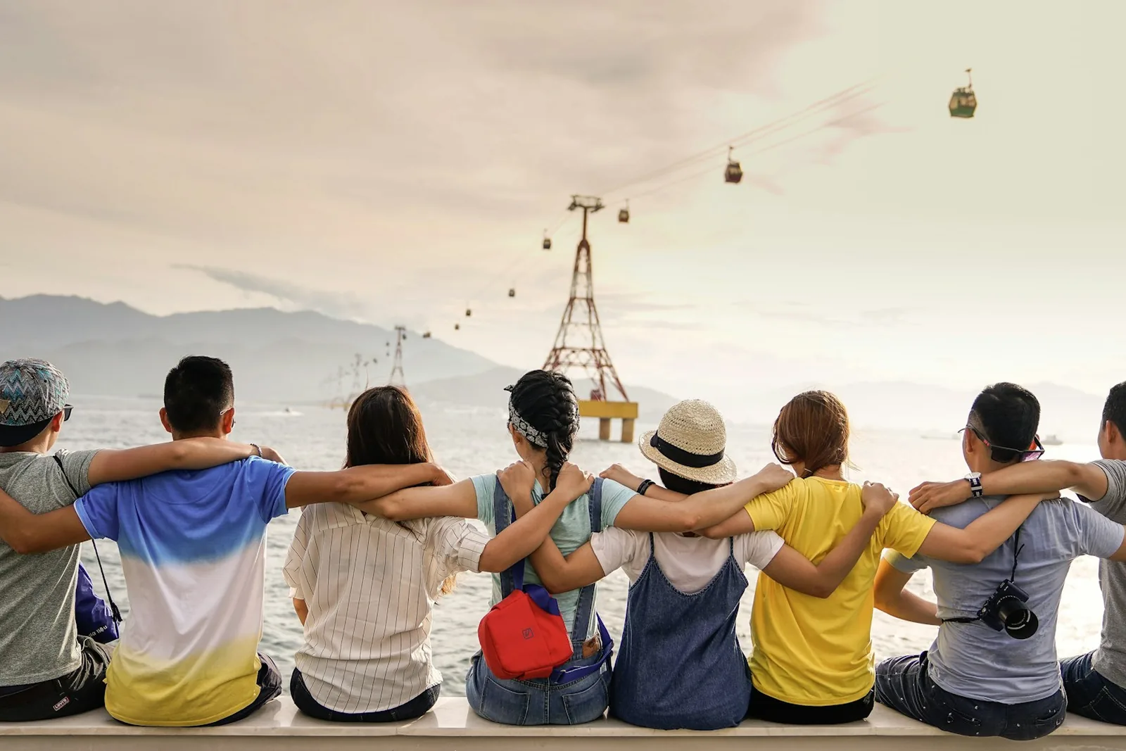 Friends sitting together with arms around one another