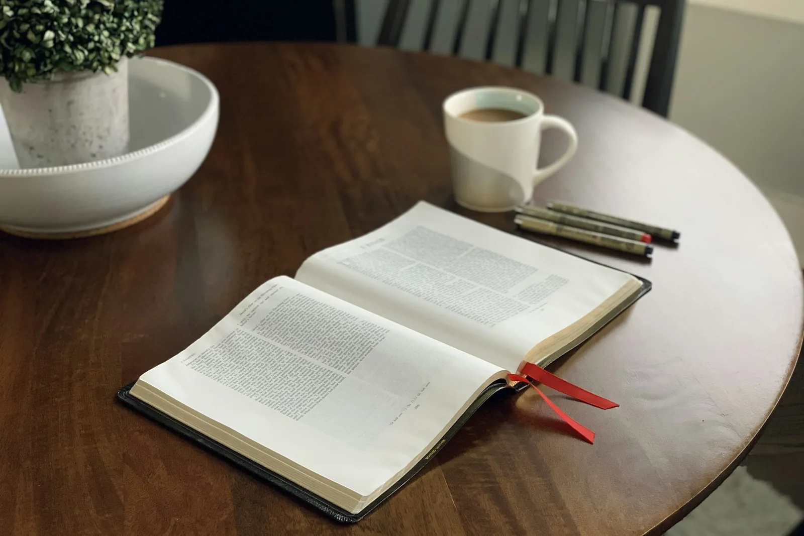 Open Bible and coffee on a table