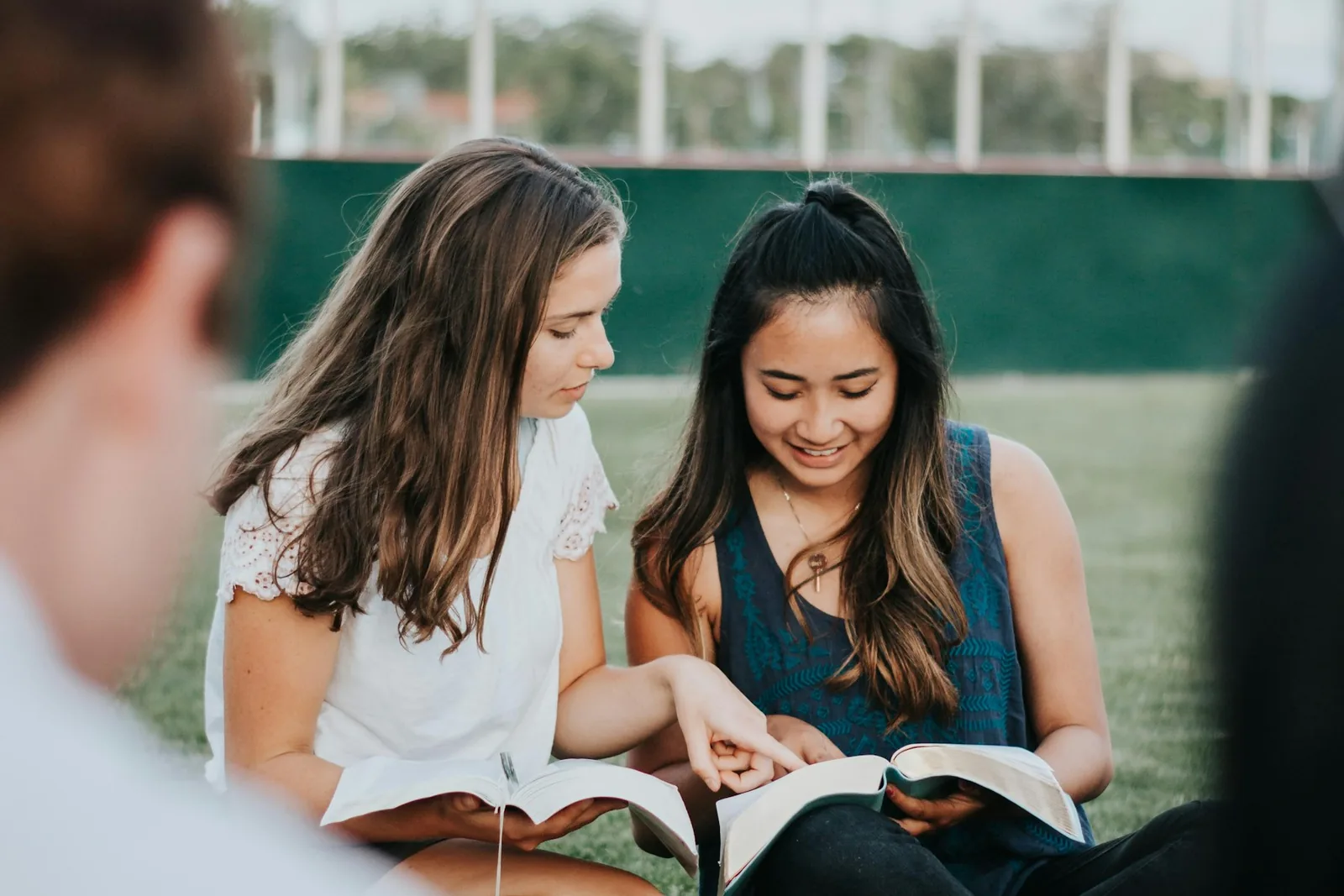 Believers studying the Bible together outdoors